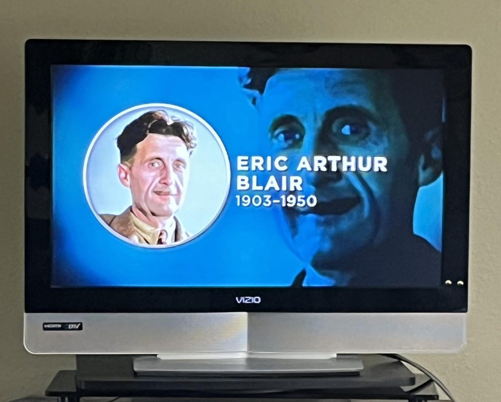 TV screen showing Eric Arthur Blair memorial tribute