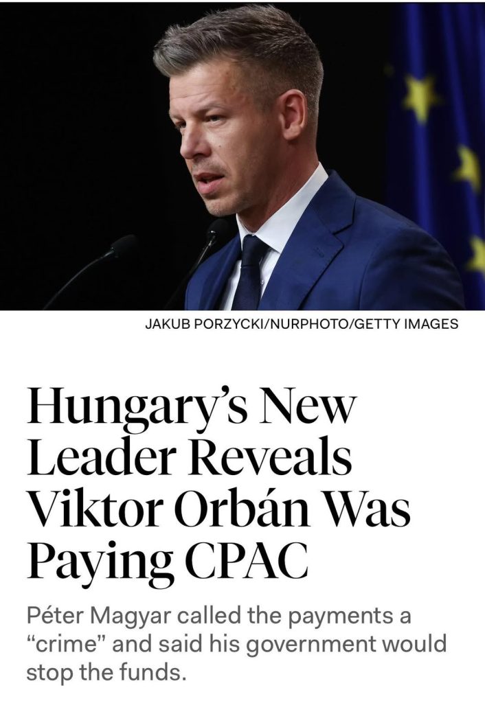 Hungarian official speaking at podium with EU flag