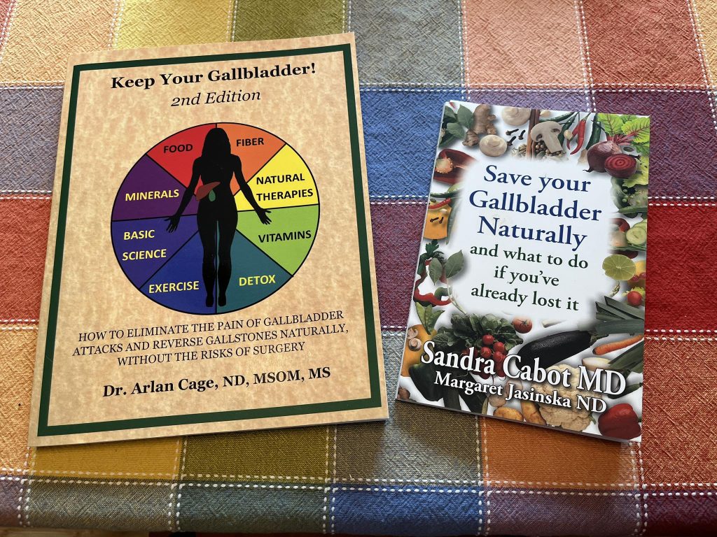 Two gallbladder health books on colorful plaid fabric