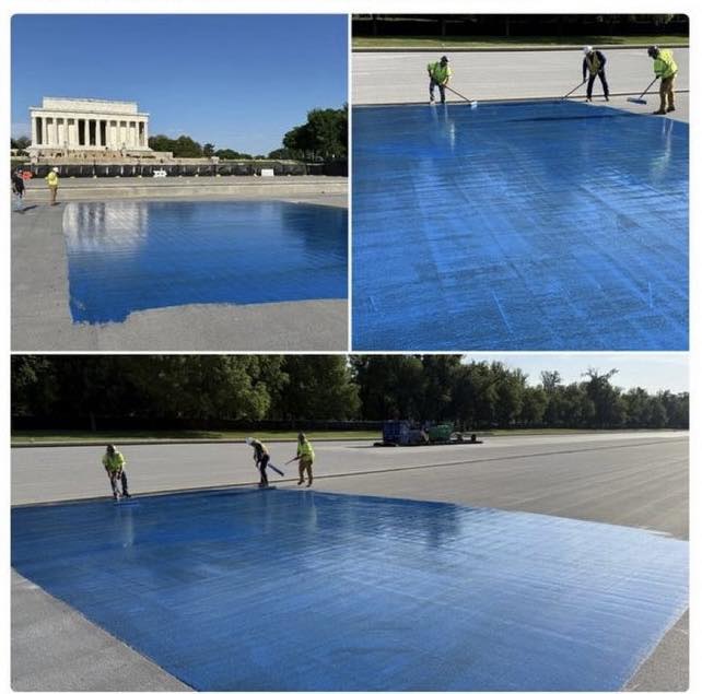 Workers painting Lincoln Memorial reflecting pool bright blue