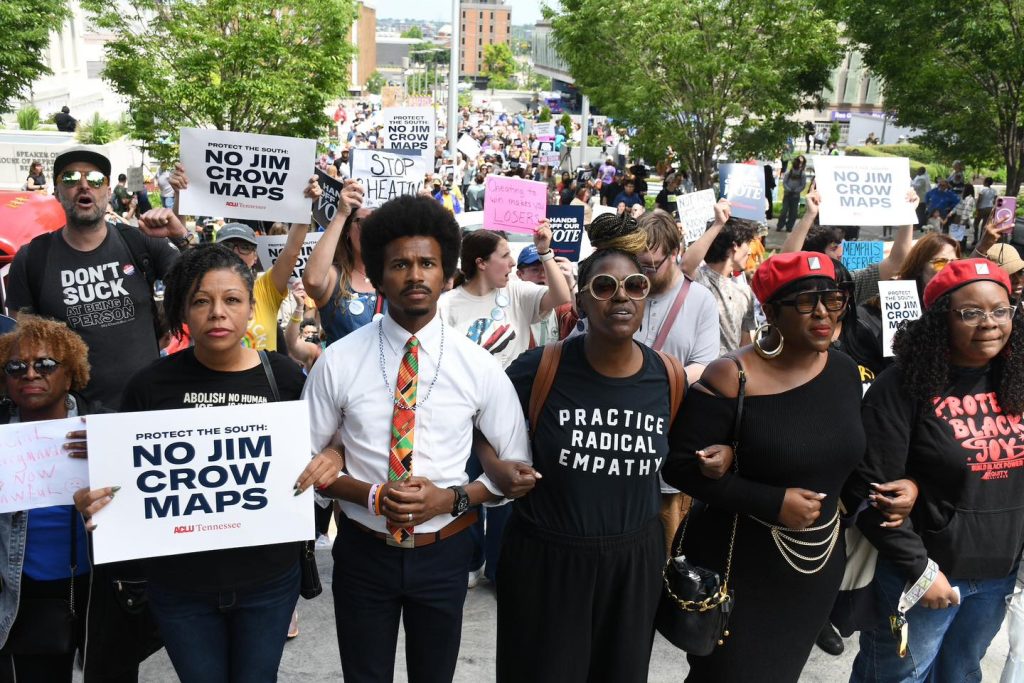 Protesters march with No Jim Crow Maps signs