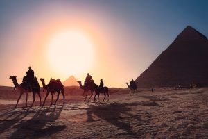 Archaeologists working at a desert dig site in the Dakhla Oasis at sunset