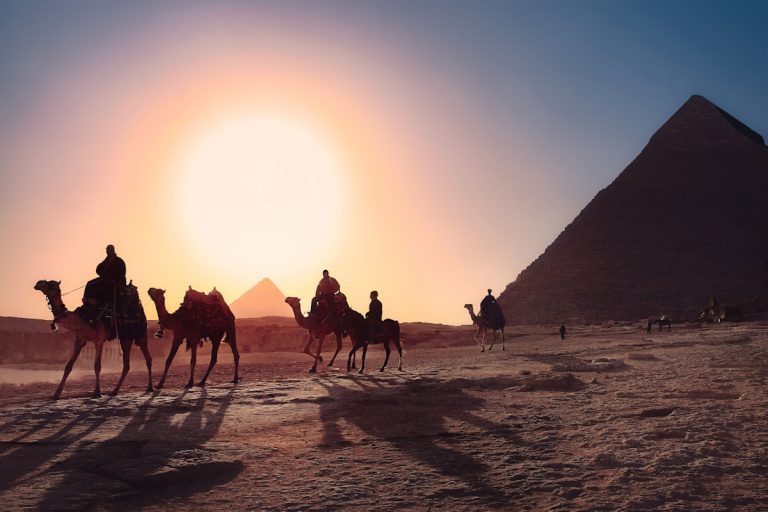 Archaeologists working at a desert dig site in the Dakhla Oasis at sunset