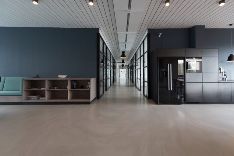 A bright, open-plan hybrid office with integrated remote collaboration technology