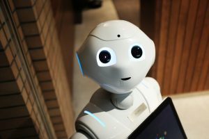 A sleek humanoid robot standing in a tech lab